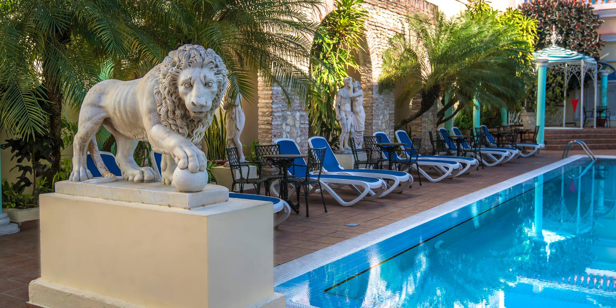 a statue of a lion next to a pool