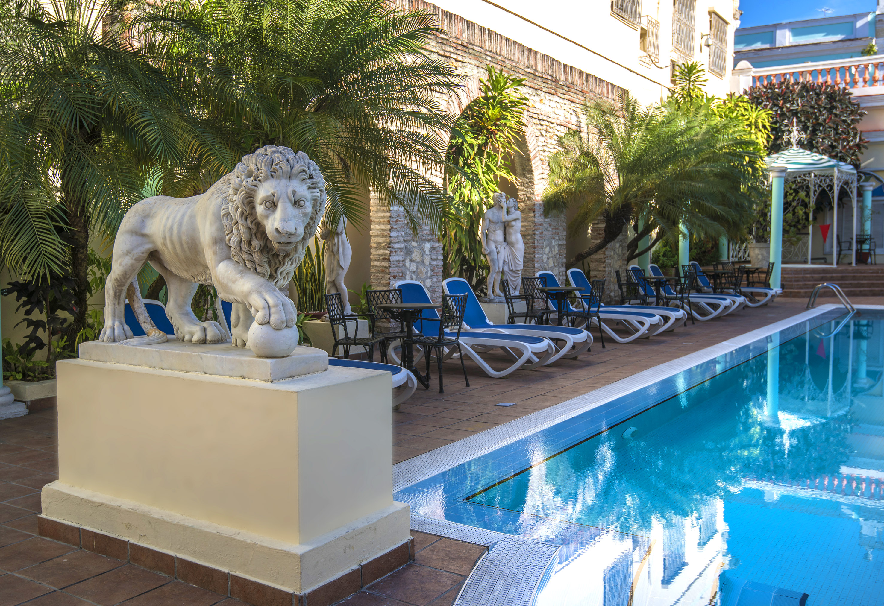 a statue of a lion next to a pool
