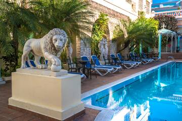 a statue of a lion next to a pool