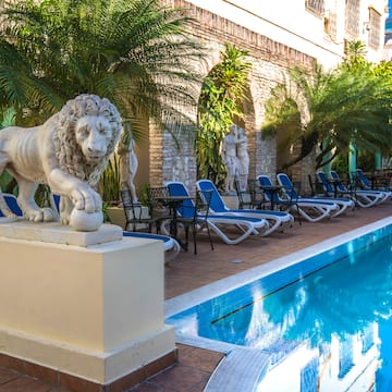 a statue of a lion next to a pool