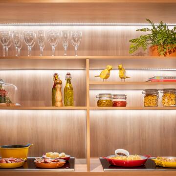 a shelf with food and wine glasses