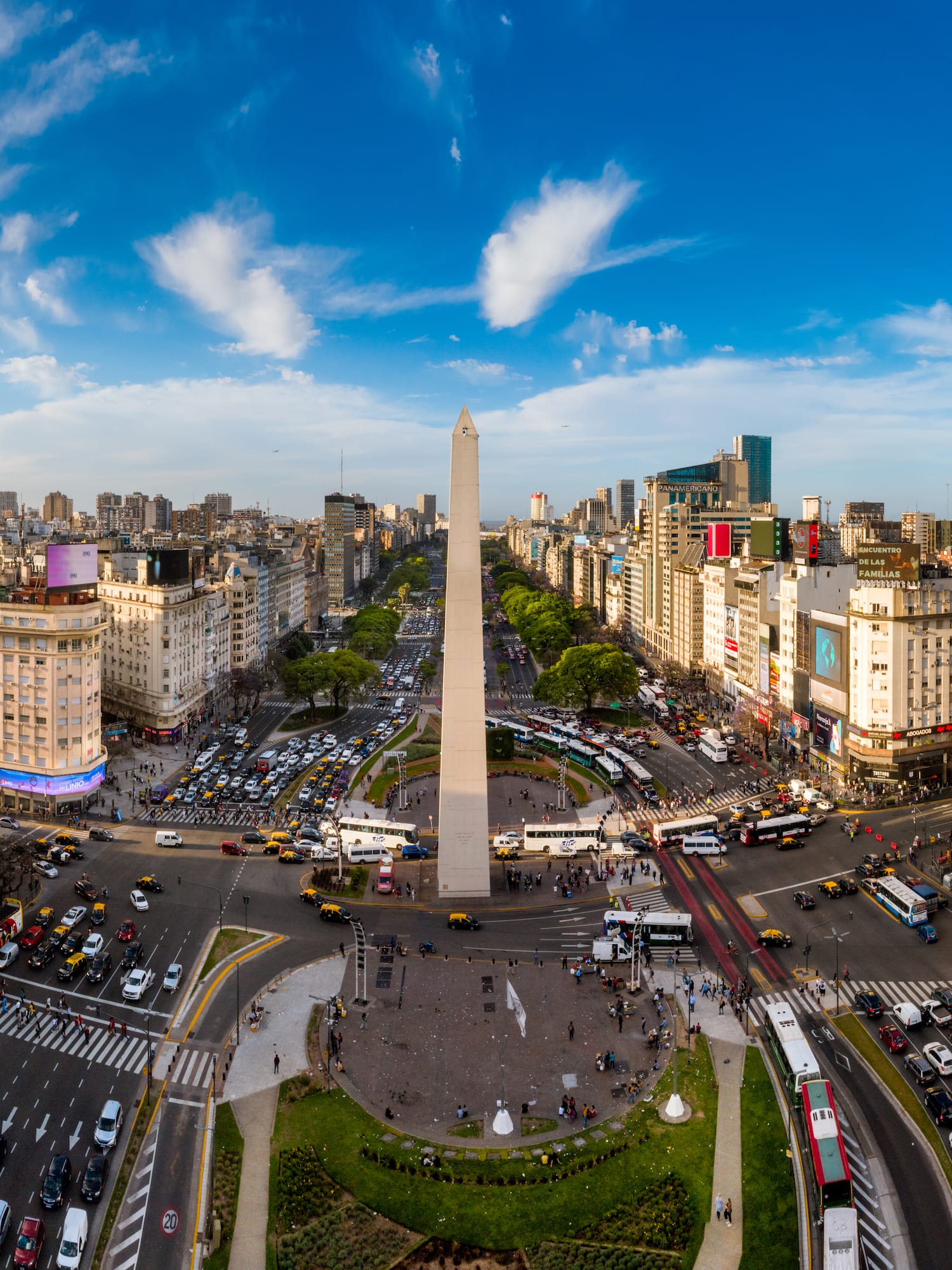 a city with a monument and many cars and buildings