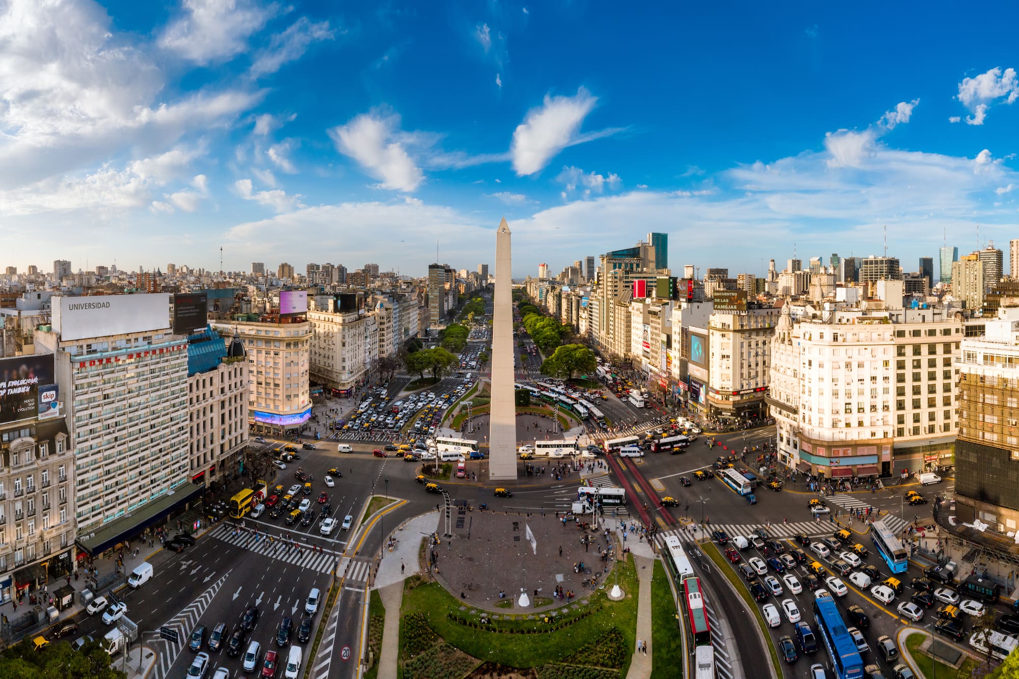 a city with a monument and many cars and buildings