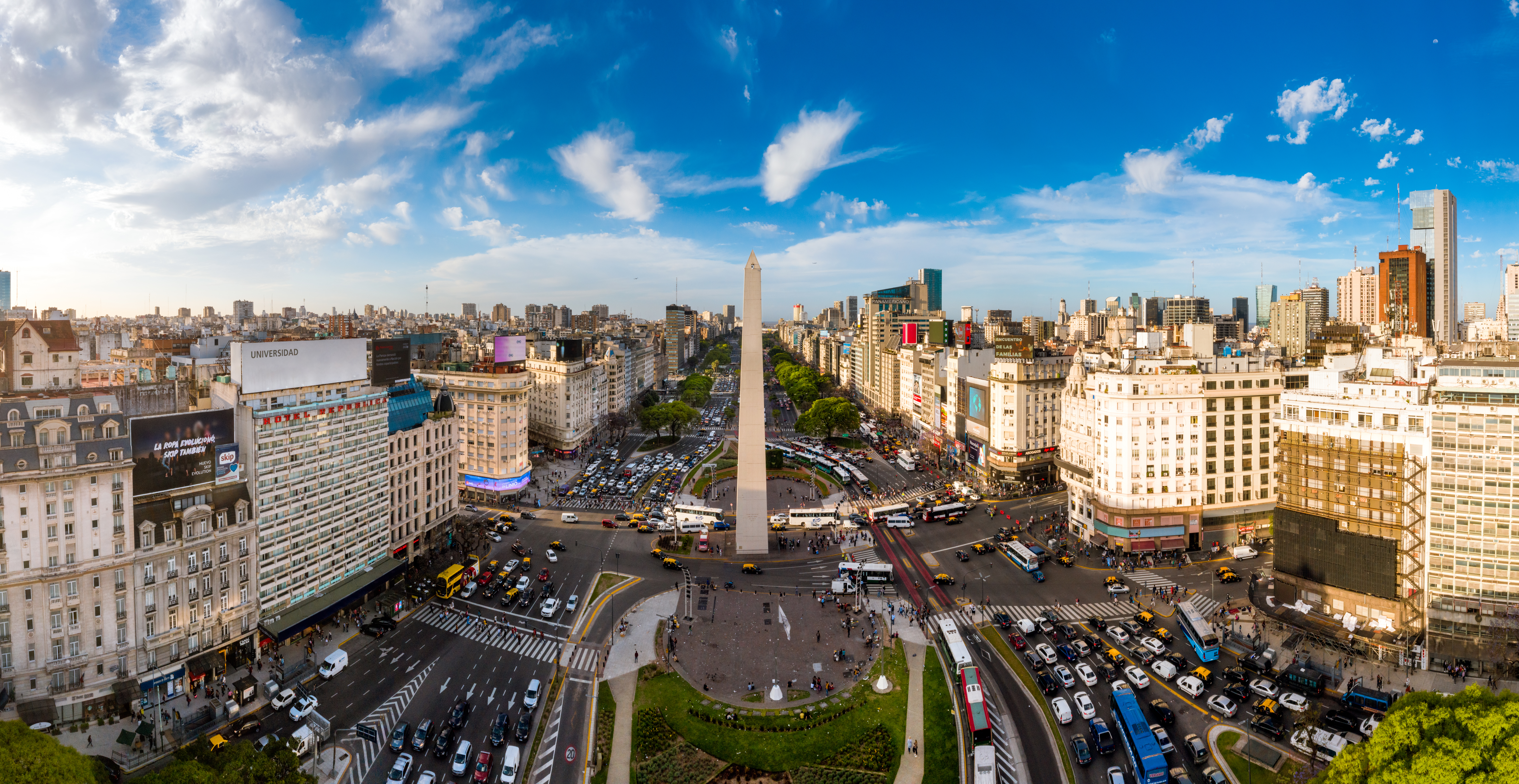 a city with a monument and many cars and buildings