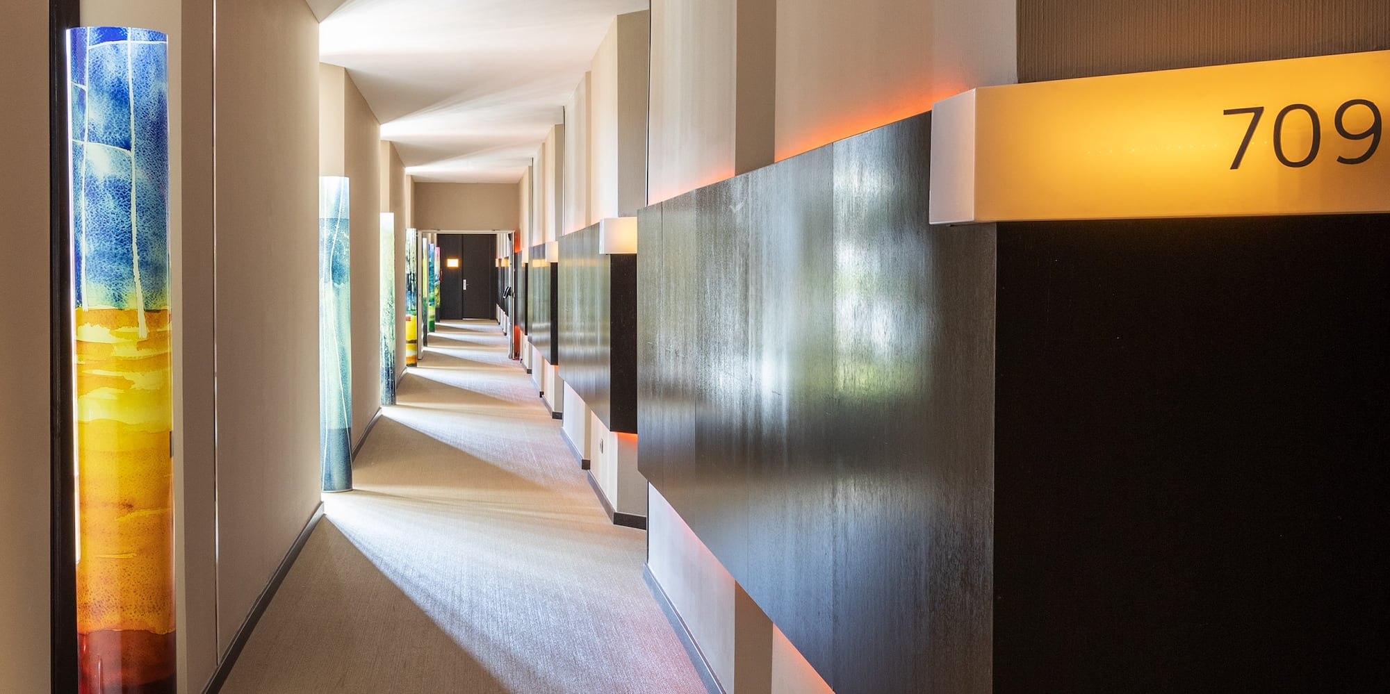 a hallway with a light shining on the walls