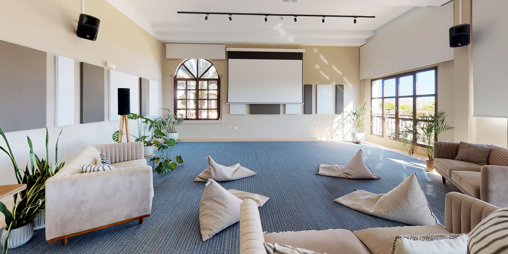 a room with a large white screen and a couch