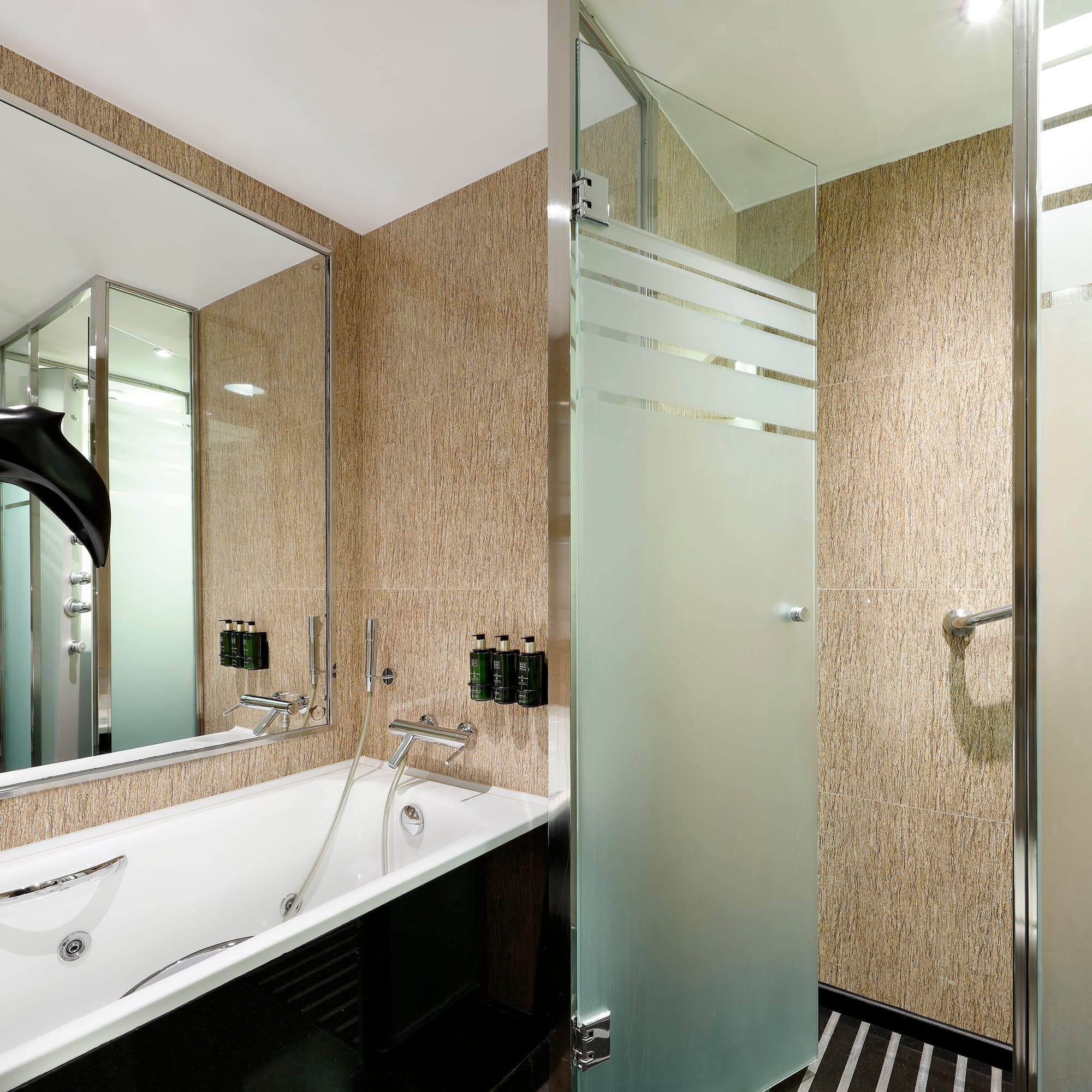 a bathroom with a bathtub and shower