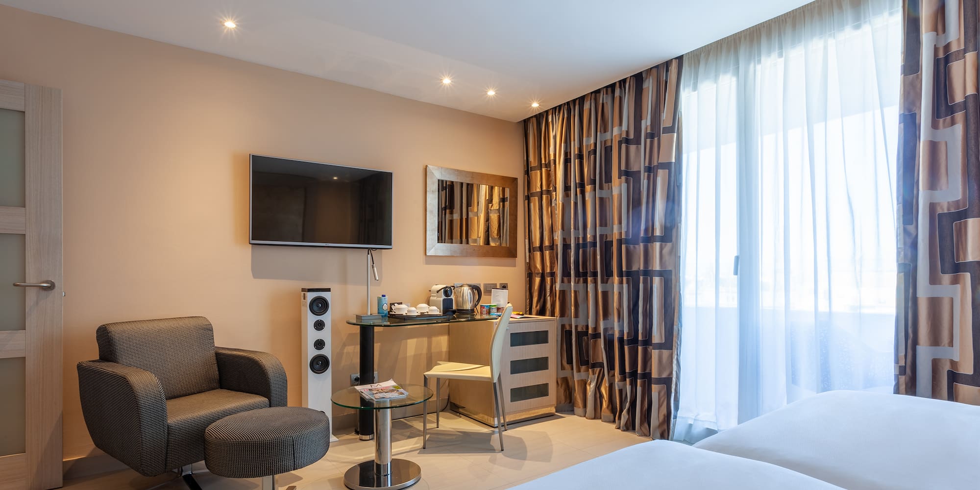 a room with a bed and a television