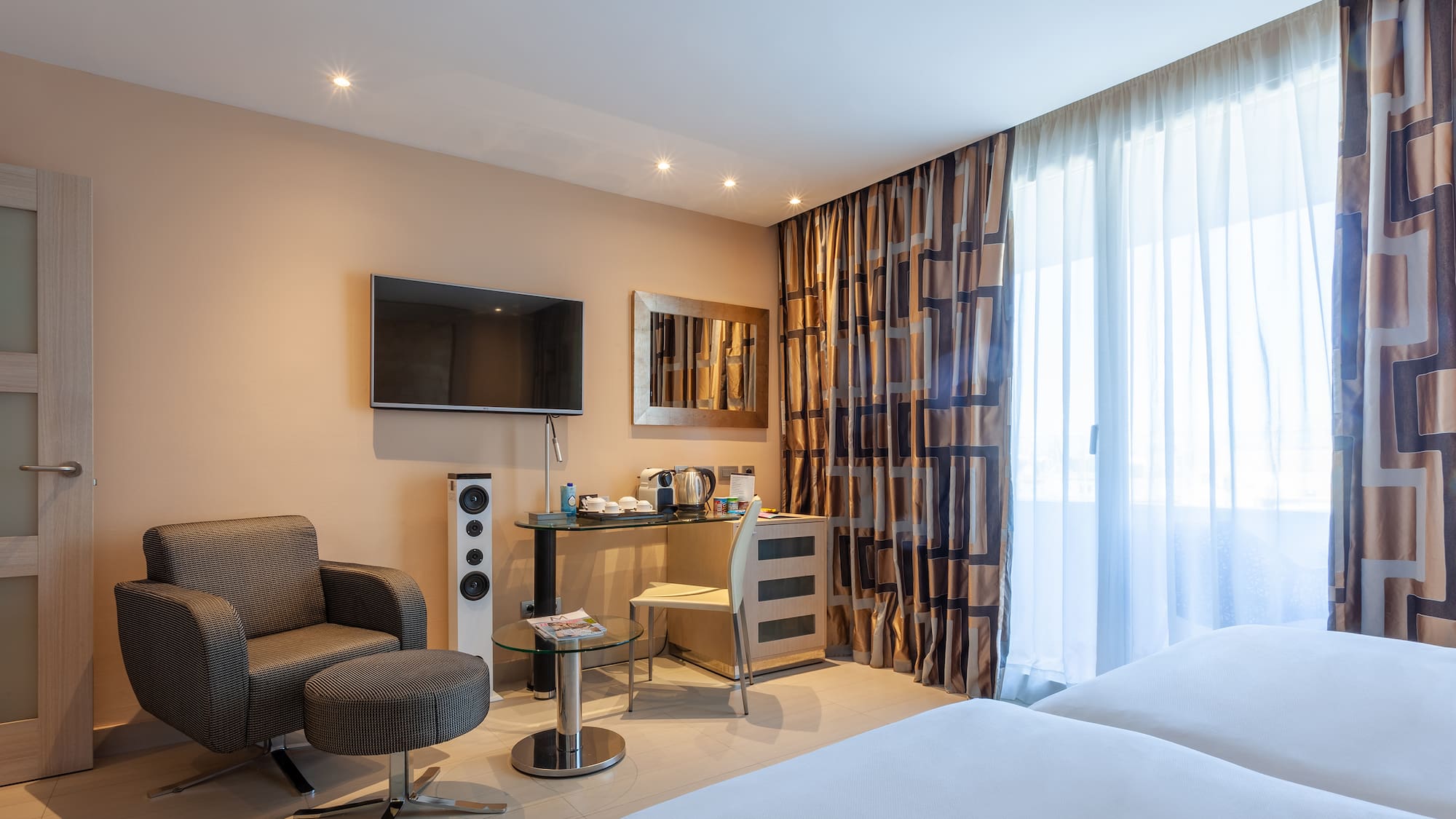 a room with a bed and a television