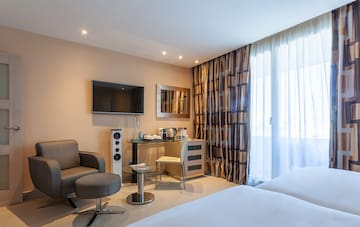 a room with a bed and a television
