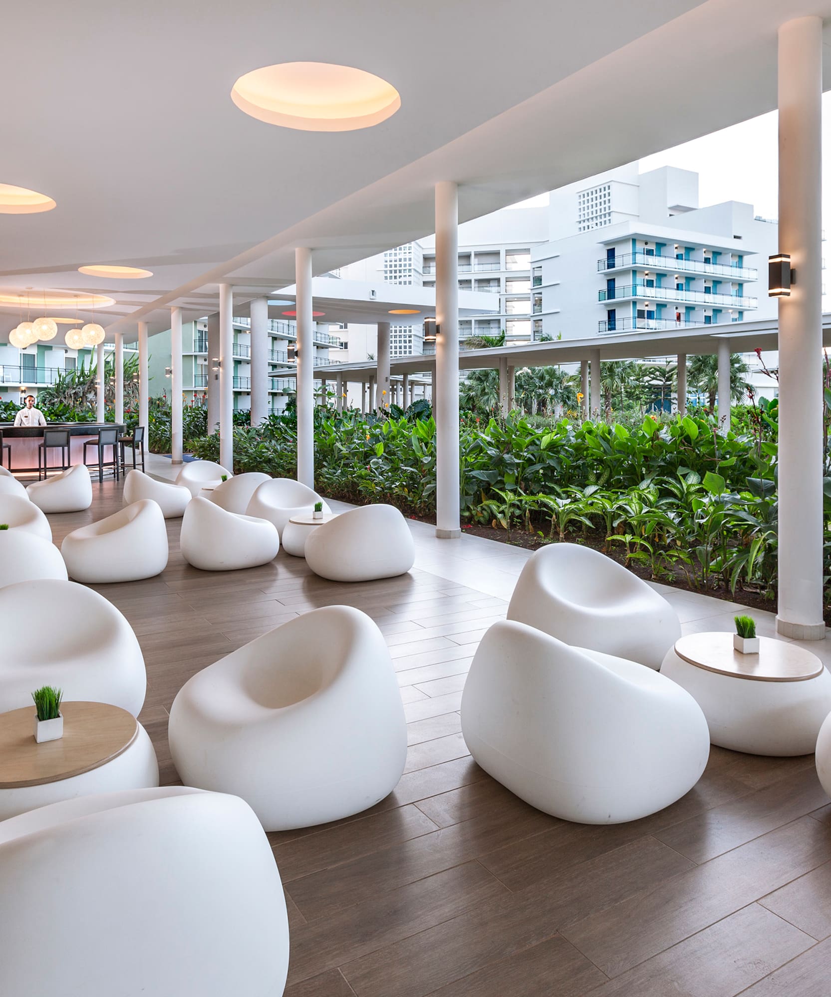 a room with white chairs and tables