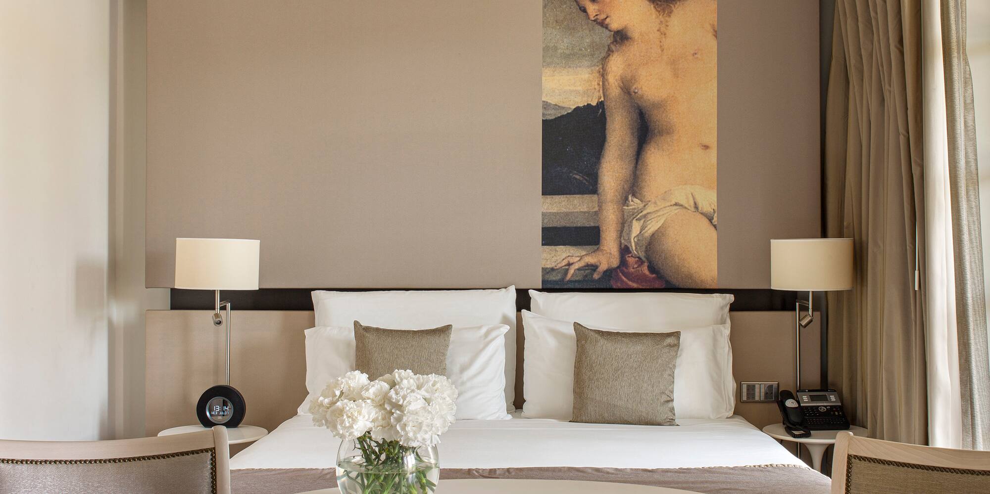 a room with a bed and chairs