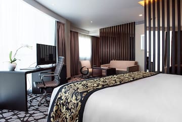 a room with a bed and a tv