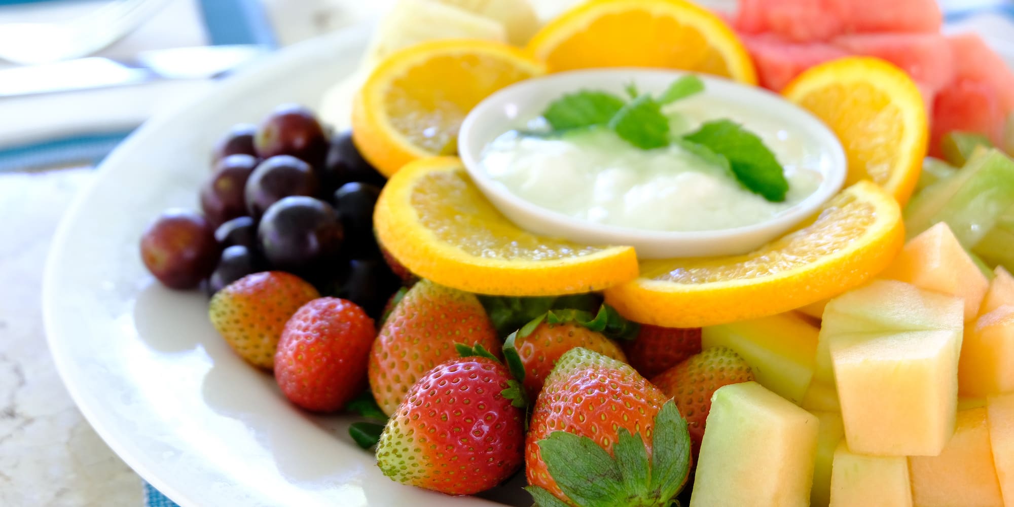 a plate of fruit and dip