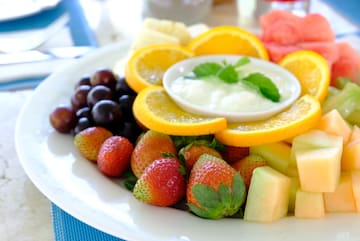 a plate of fruit and dip