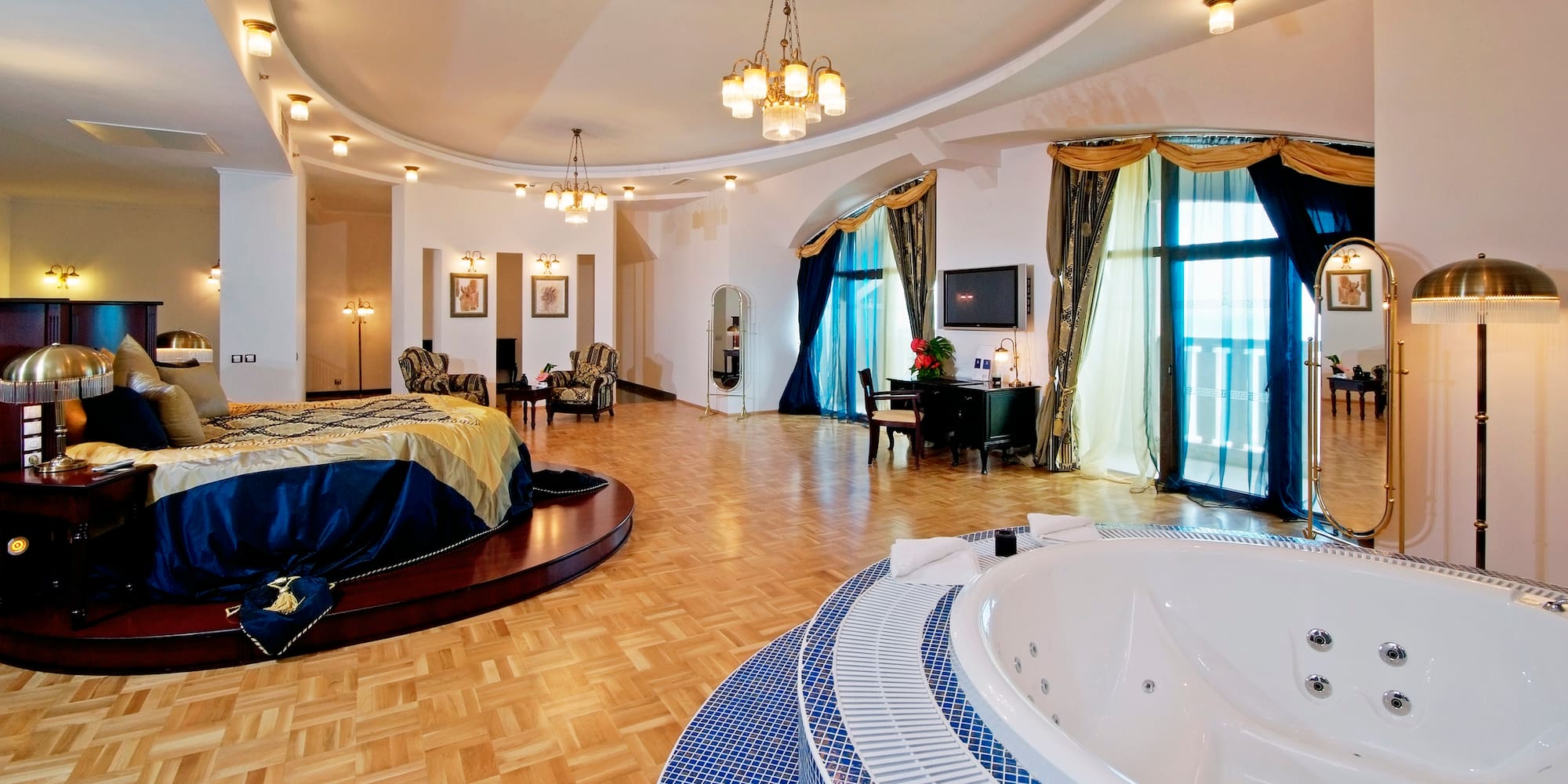 a large room with a round bed and a round tub