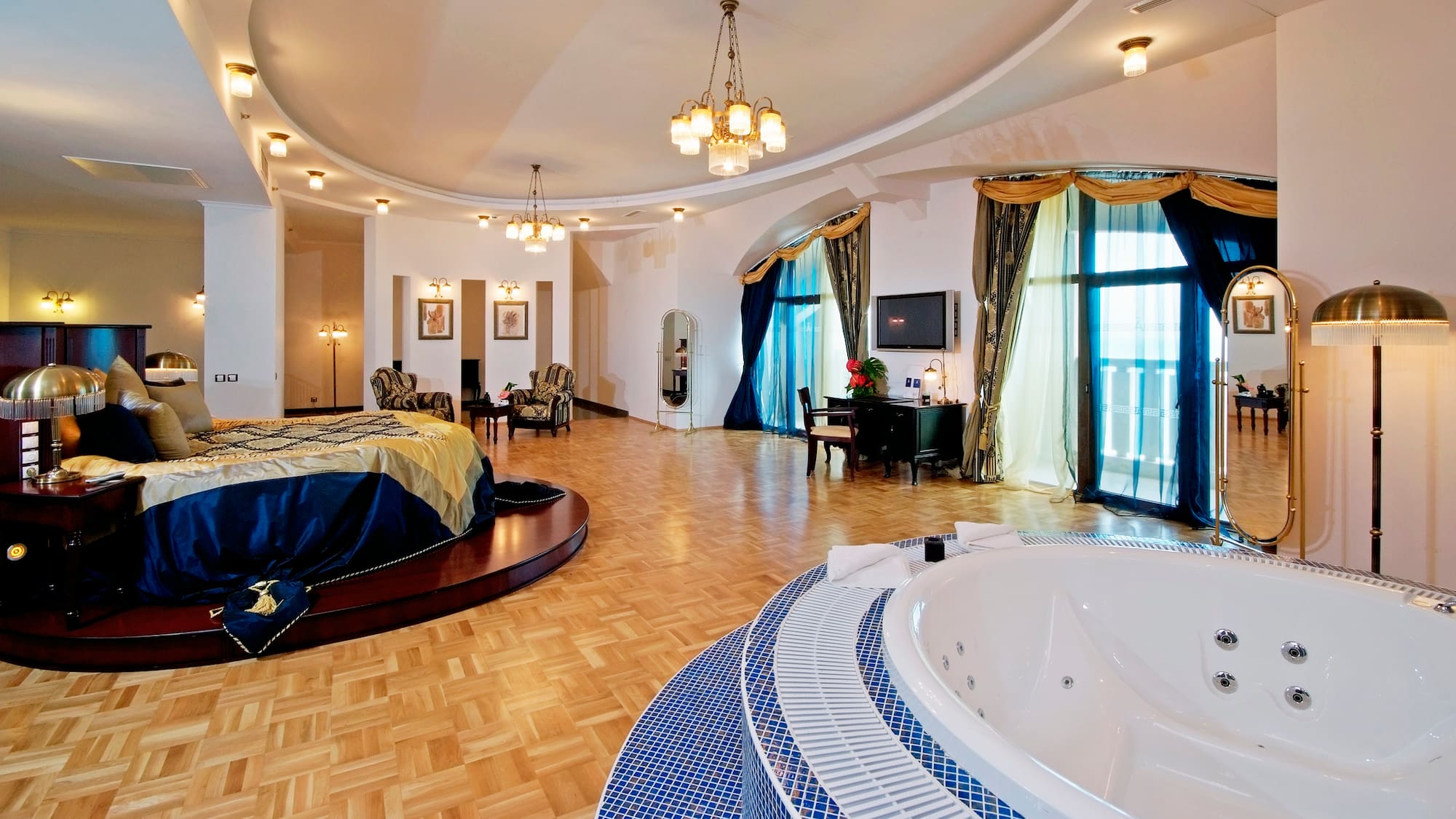 a large room with a round bed and a round tub