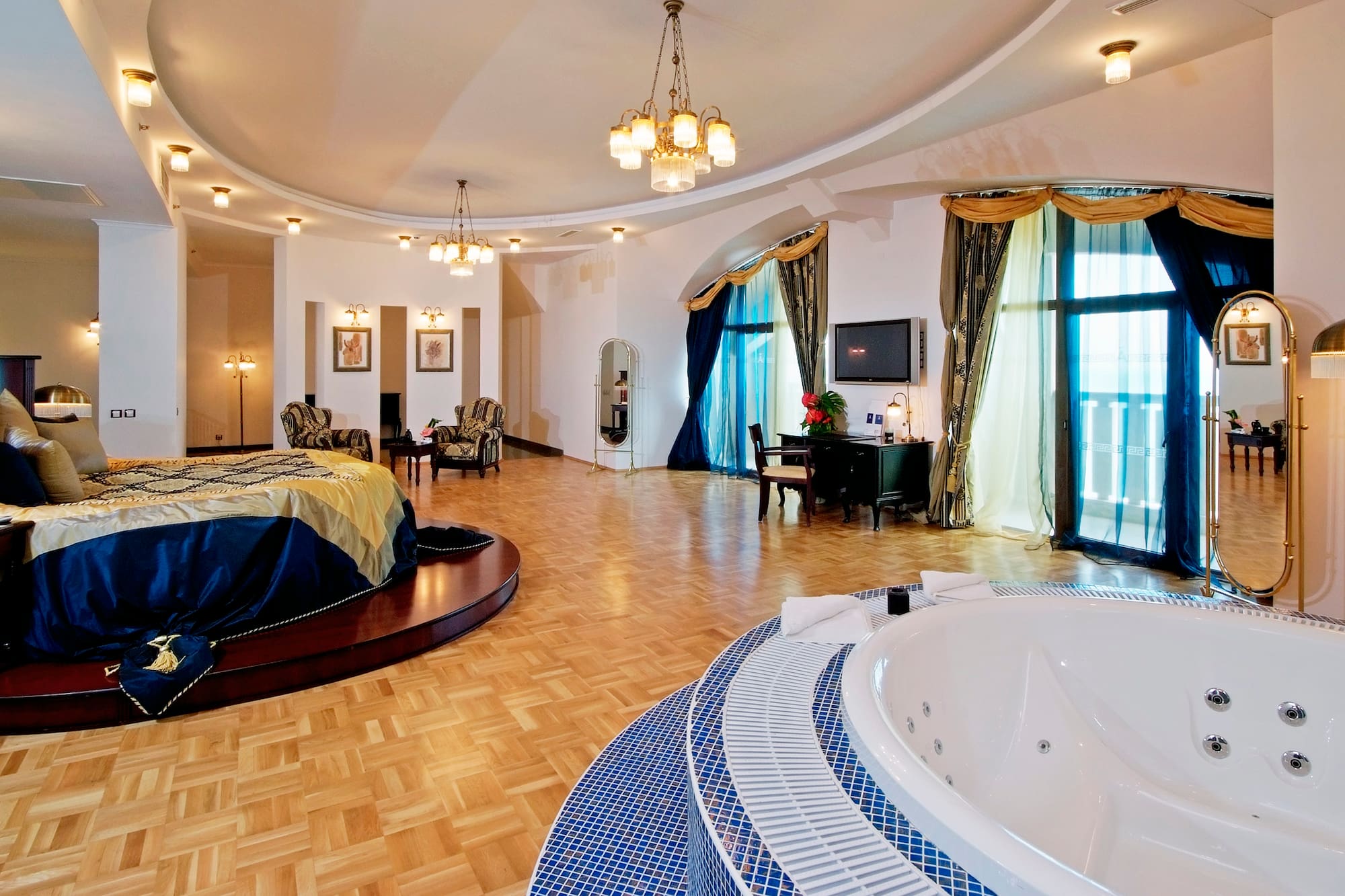a large room with a round bed and a round tub
