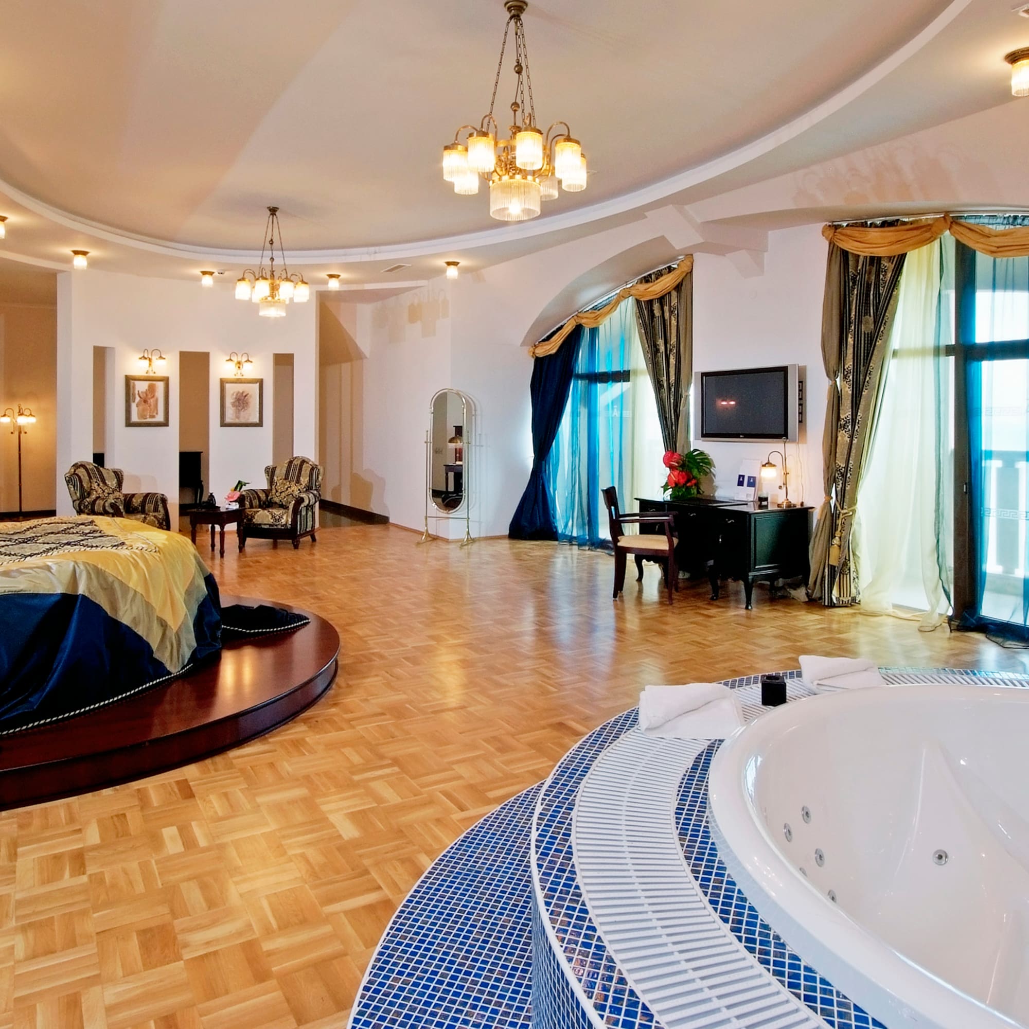 a large room with a round bed and a round tub
