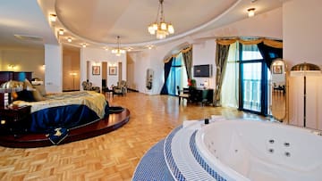 a large room with a round bed and a round tub
