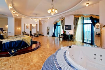a large room with a round bed and a round tub