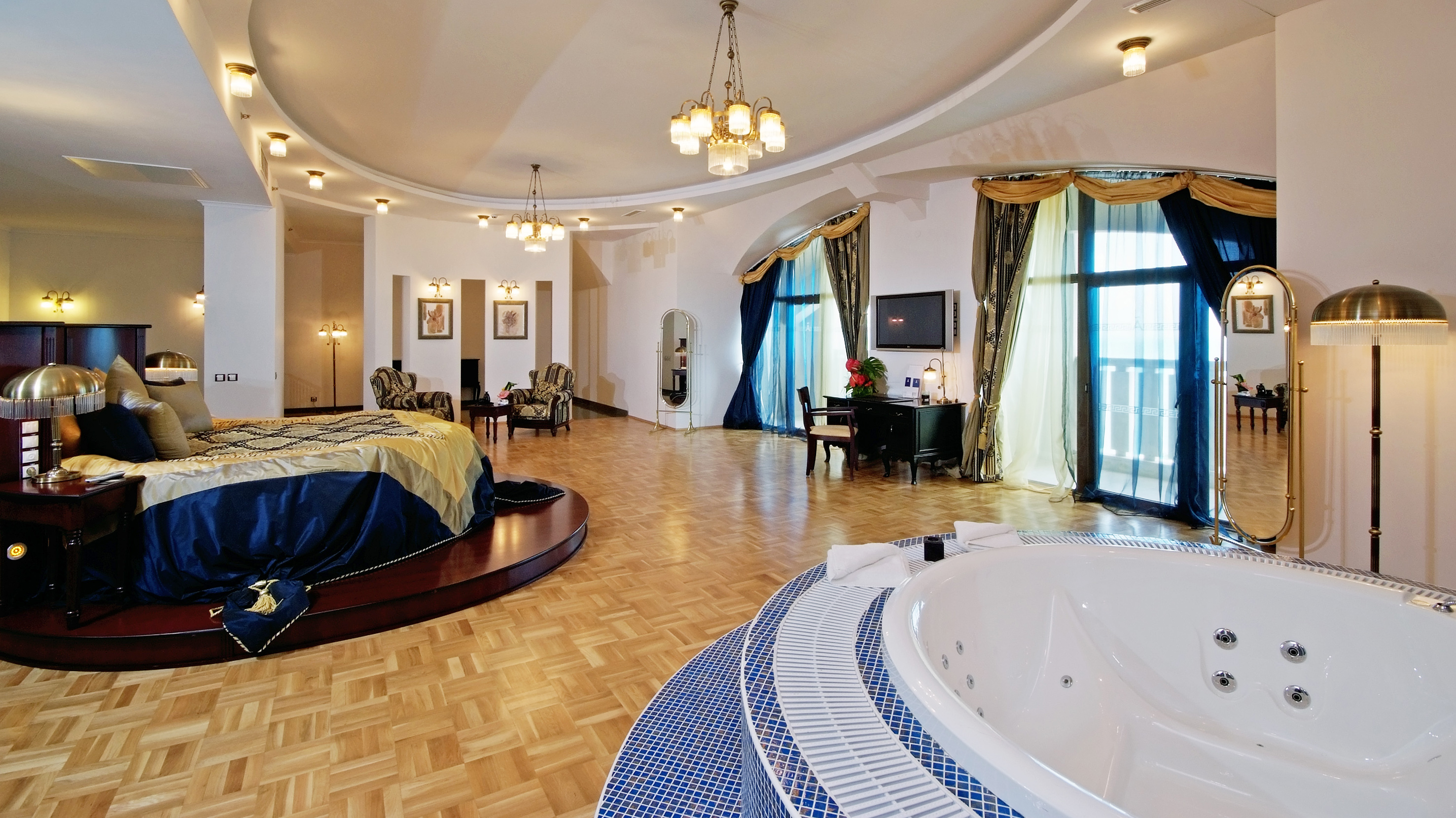 a large room with a round bed and a round tub