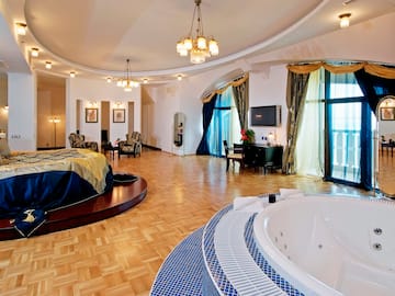 a large room with a round bed and a round tub