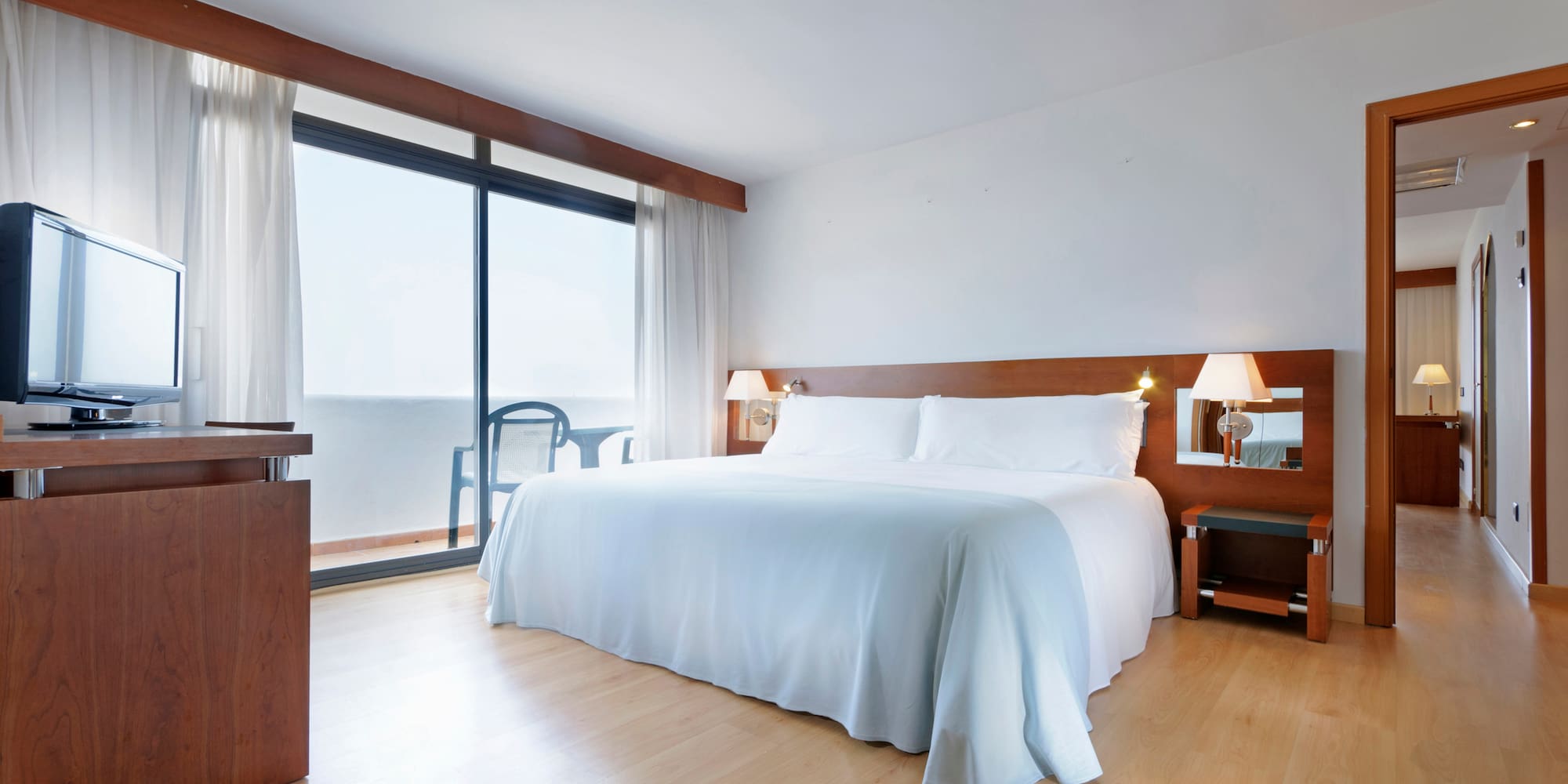 a bedroom with a large bed and a desk