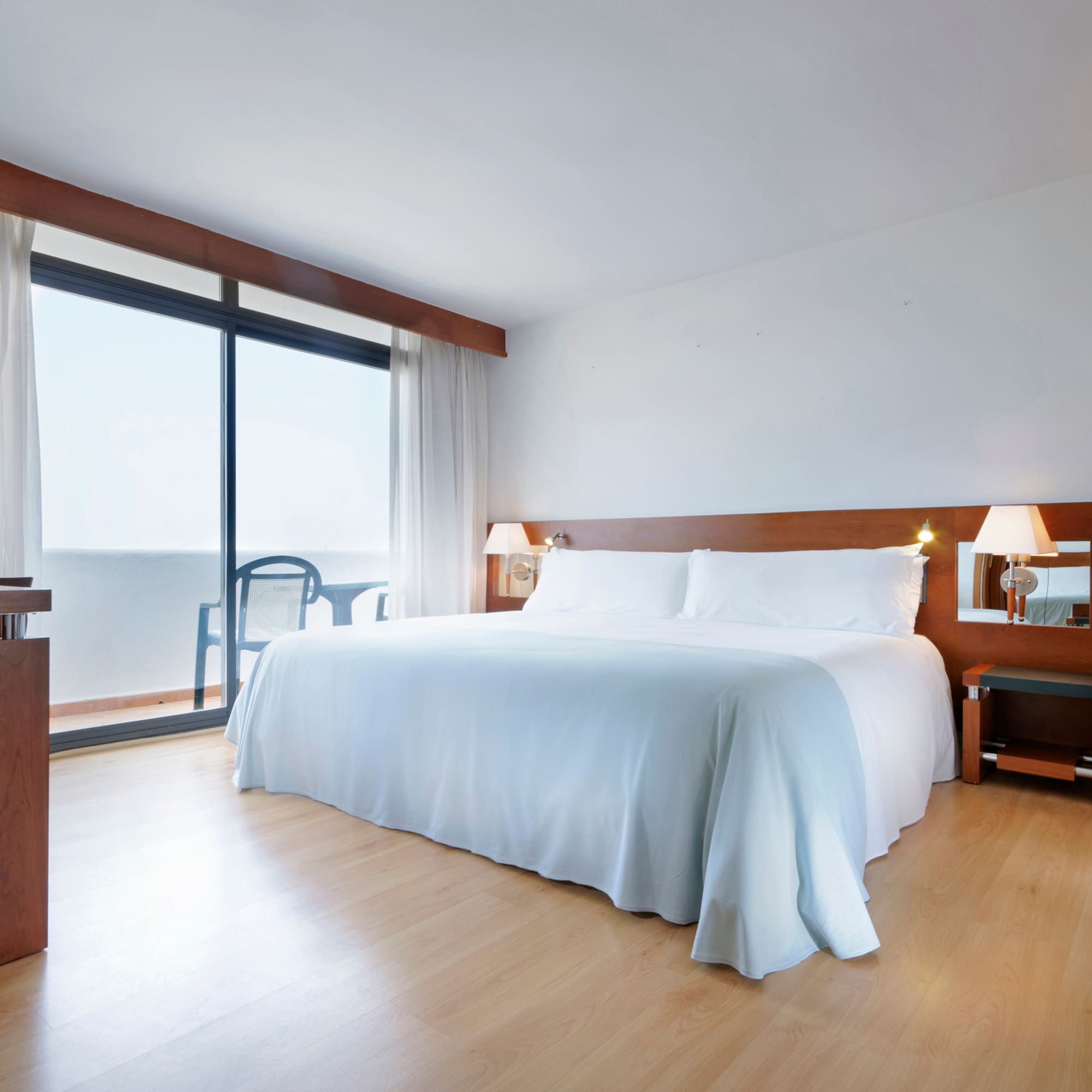 a bedroom with a large bed and a desk