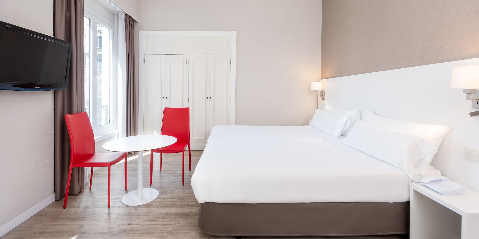 a room with a bed and chairs
