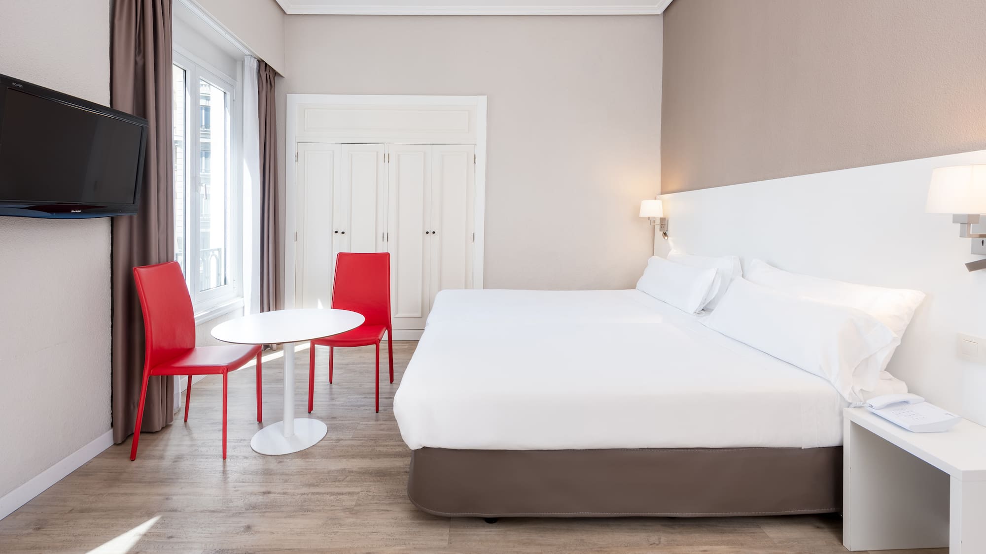 a room with a bed and chairs