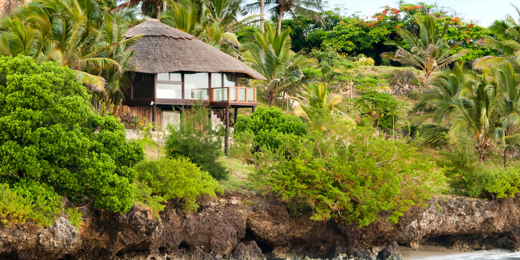 a house on a cliff by the water