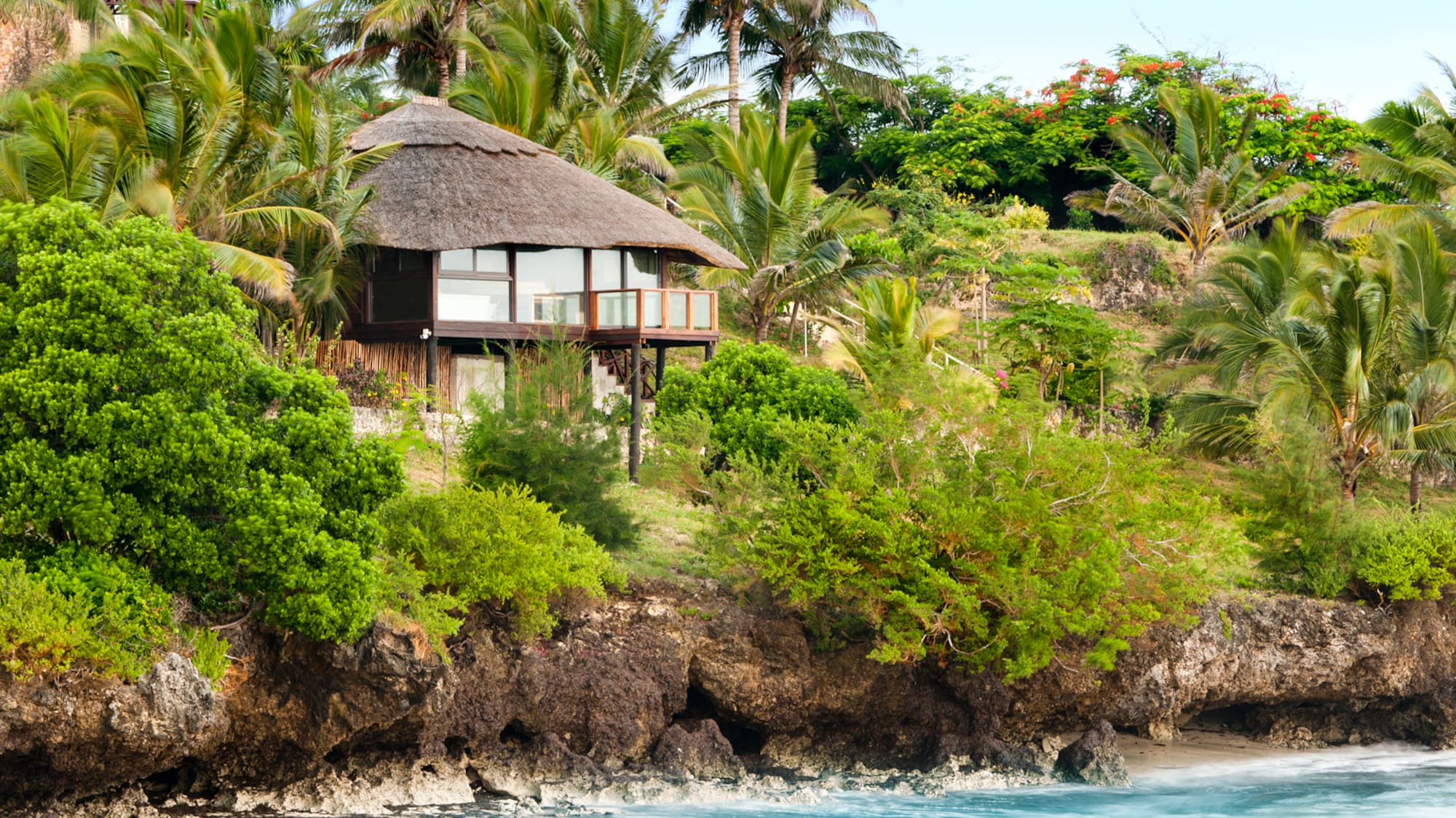 a house on a cliff by the water