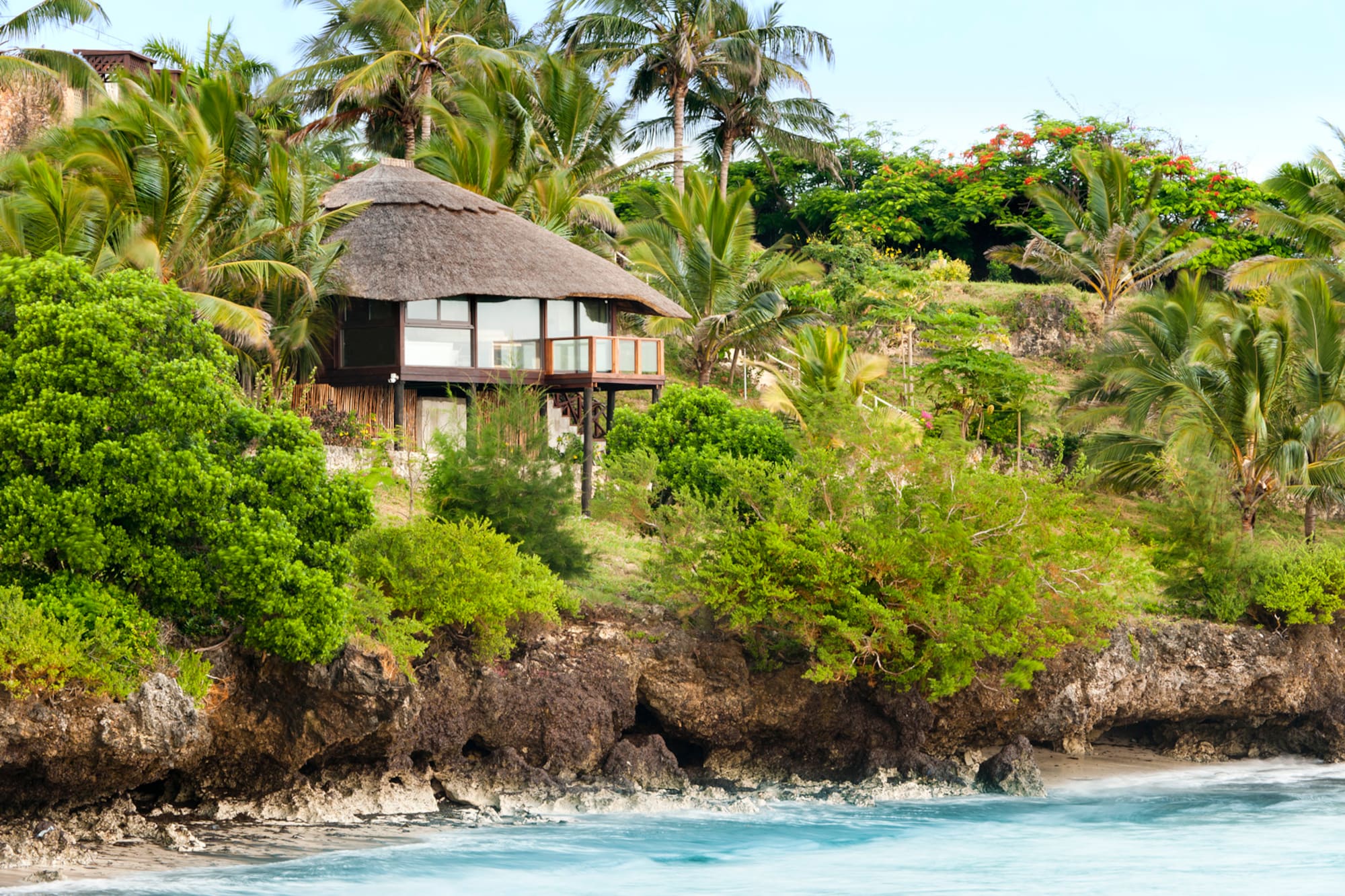 a house on a cliff by the water