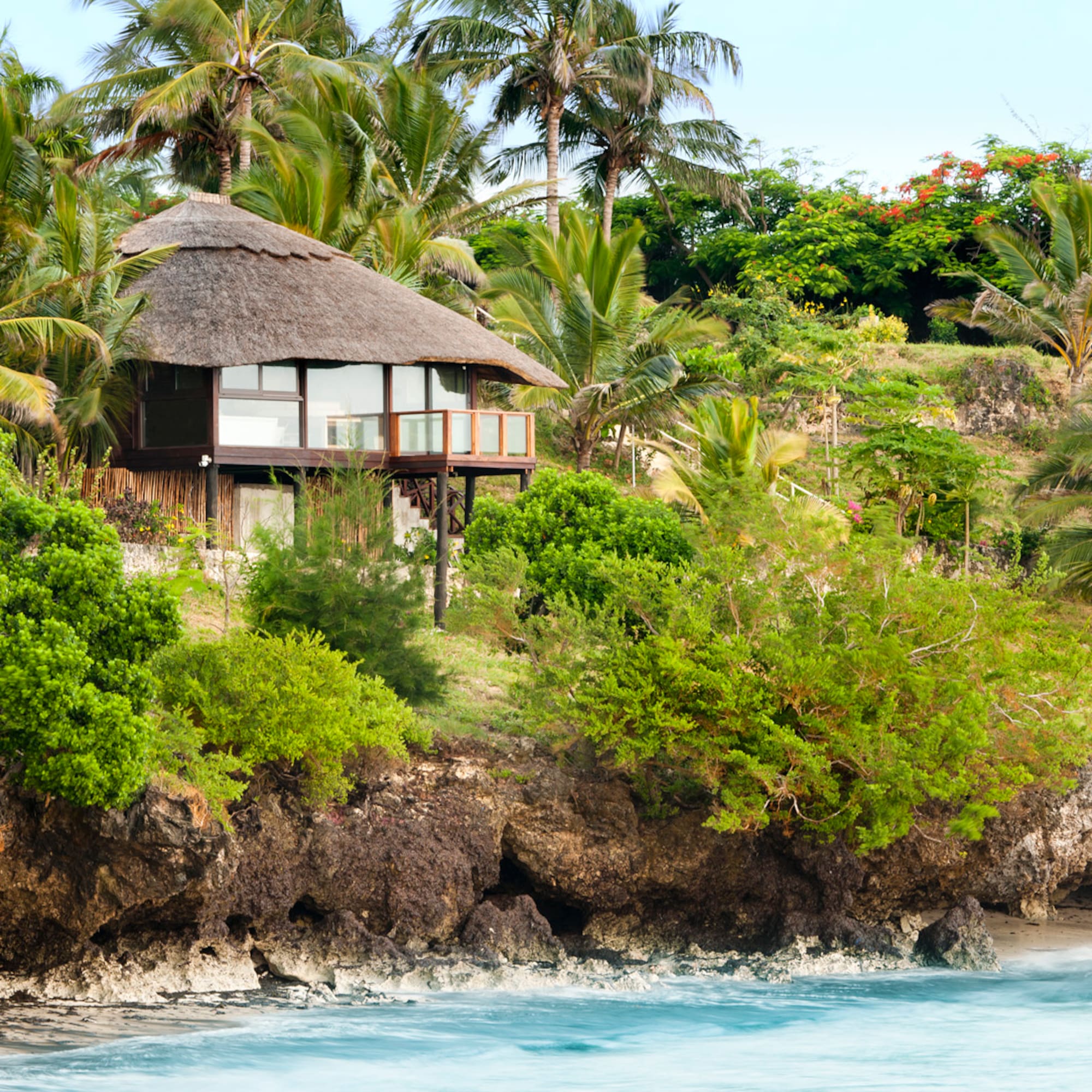 a house on a cliff by the water