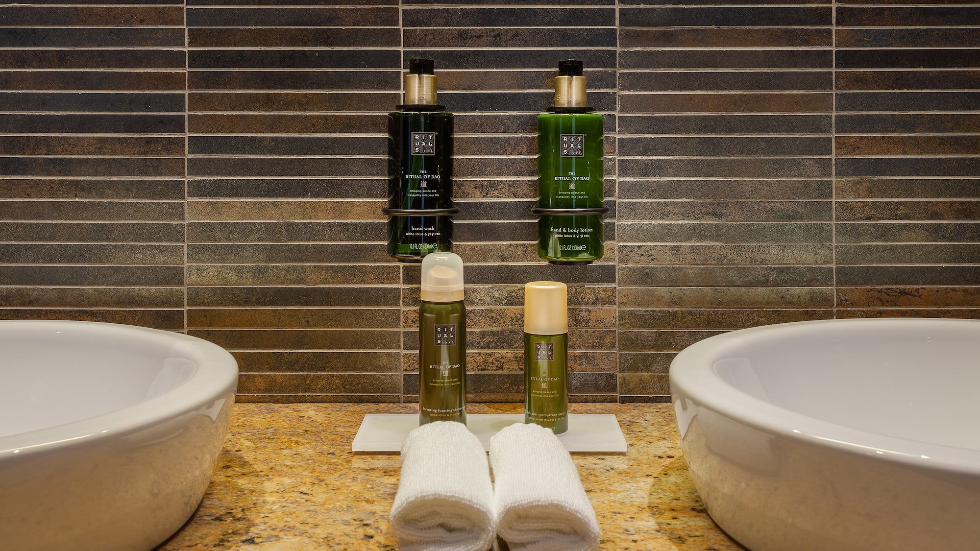 a bathroom with two sinks and two bottles of shampoo