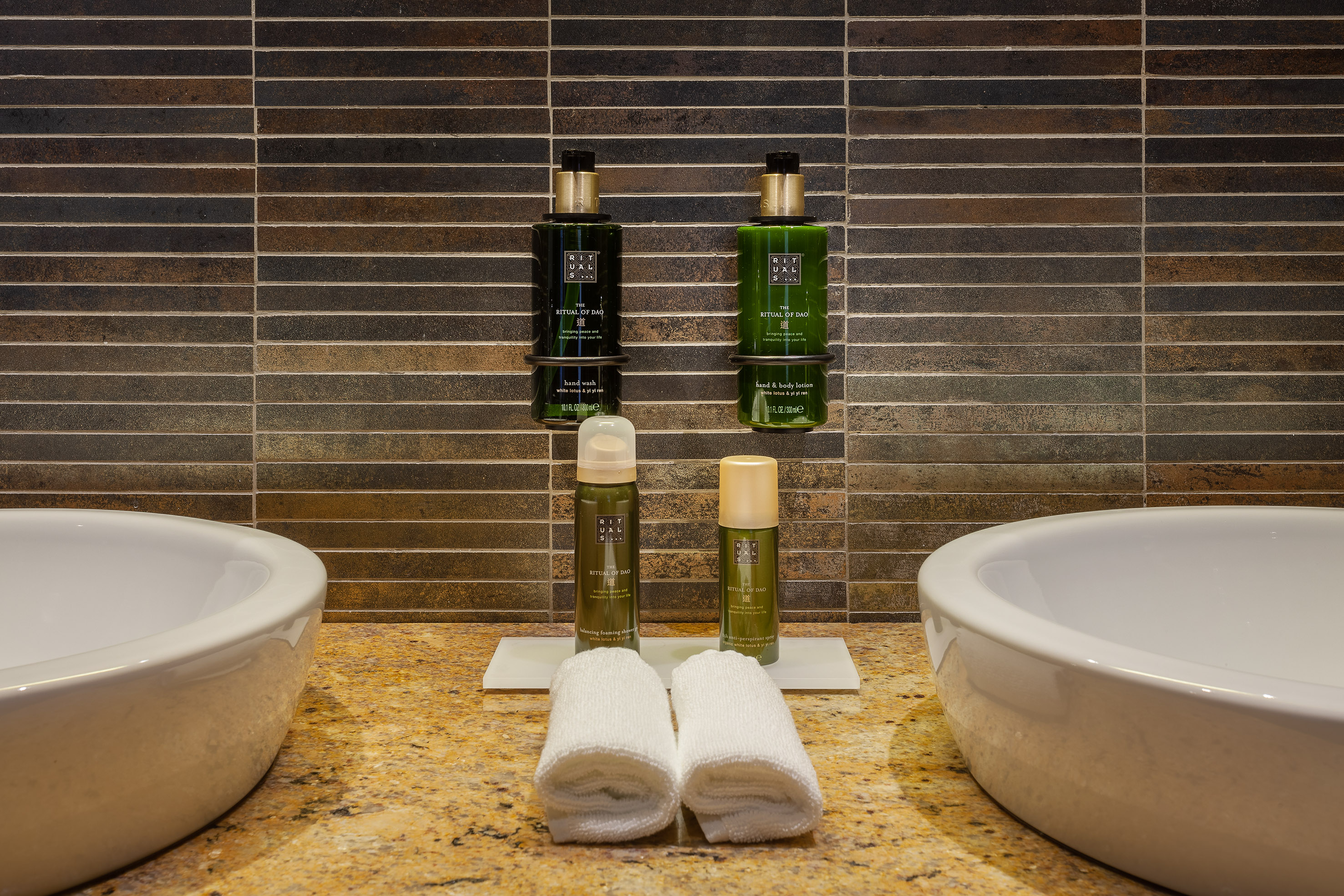 Rituals of Dao toiletries and towels on a bathroom vanity with two sinks.