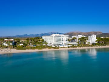 a white building next to a body of water