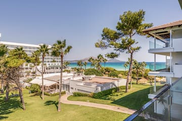 a resort with a beach and a body of water