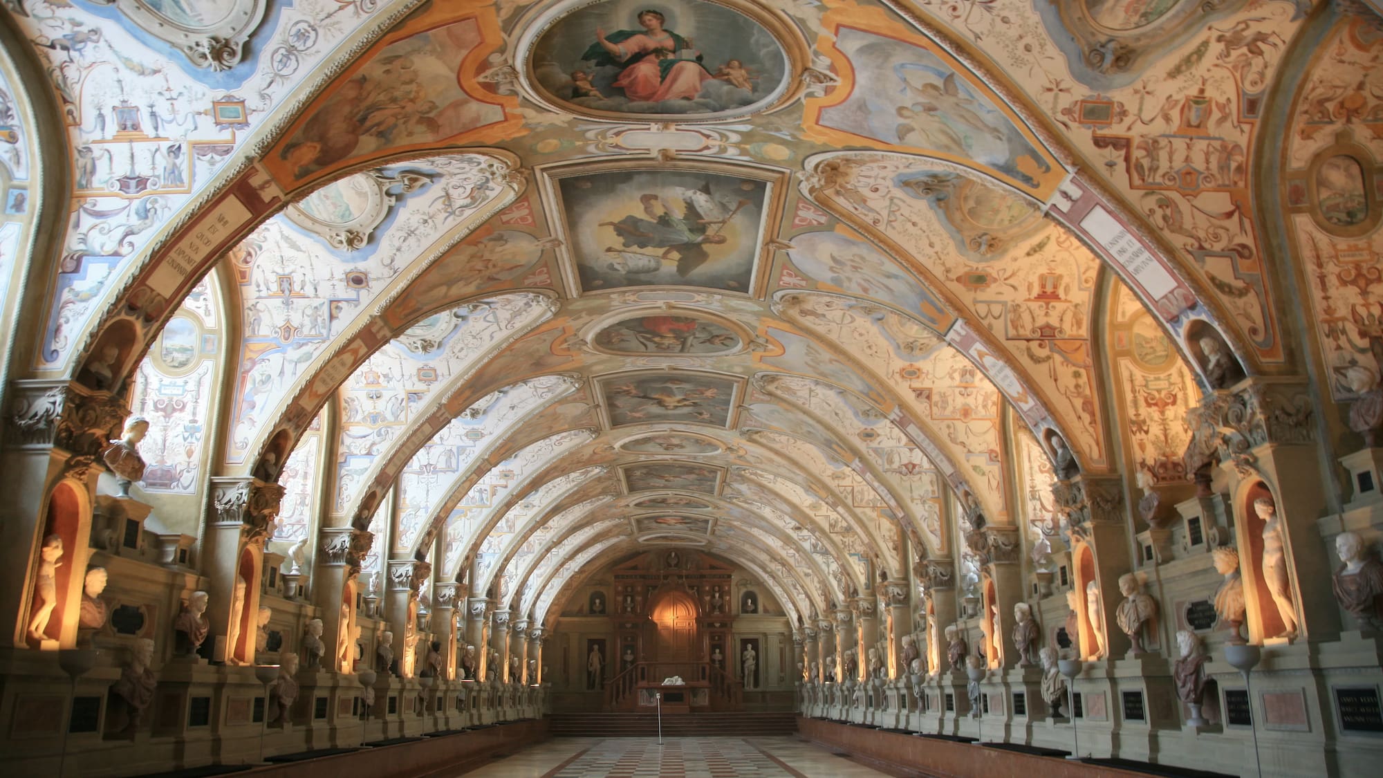 a large ornate hallway with art on the ceiling