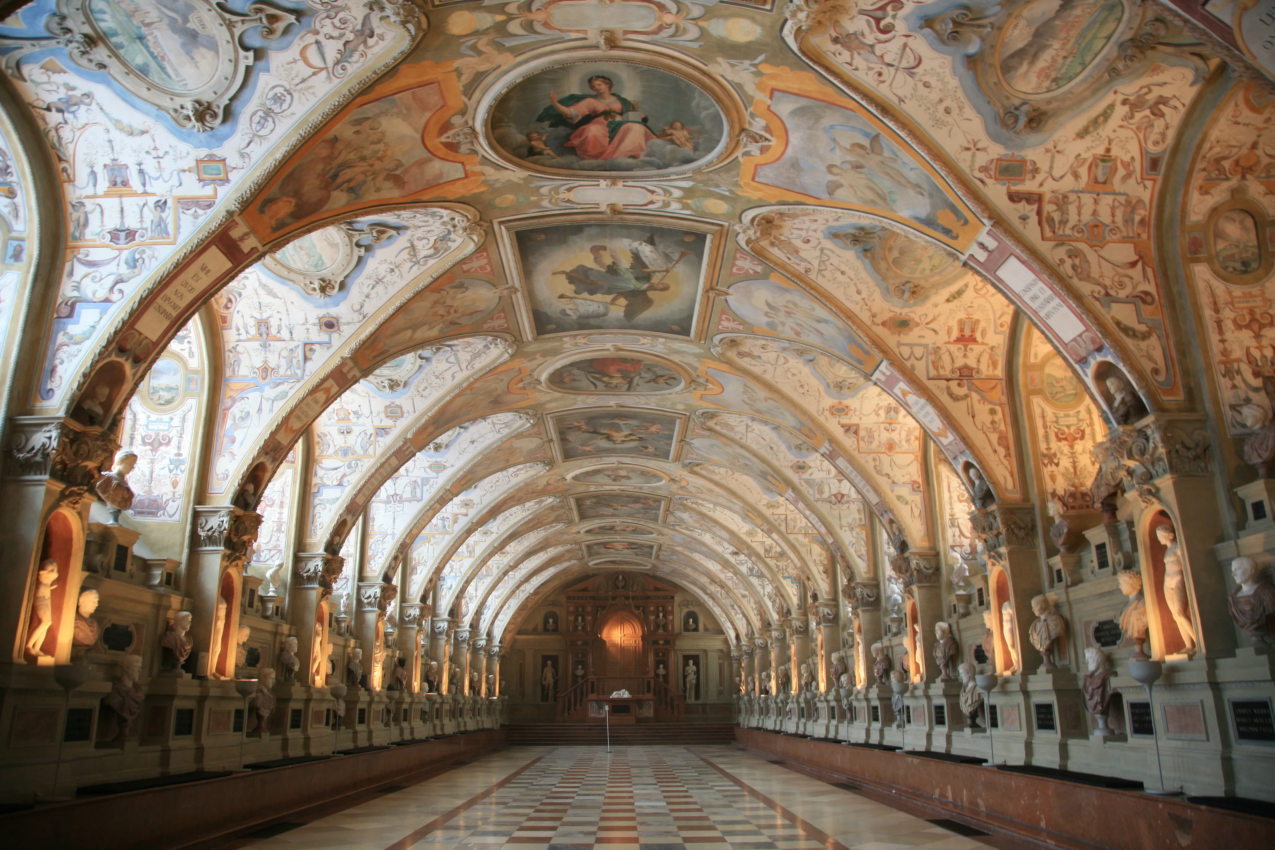a large ornate hallway with art on the ceiling