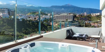 a hot tub with a view of a city and mountains
