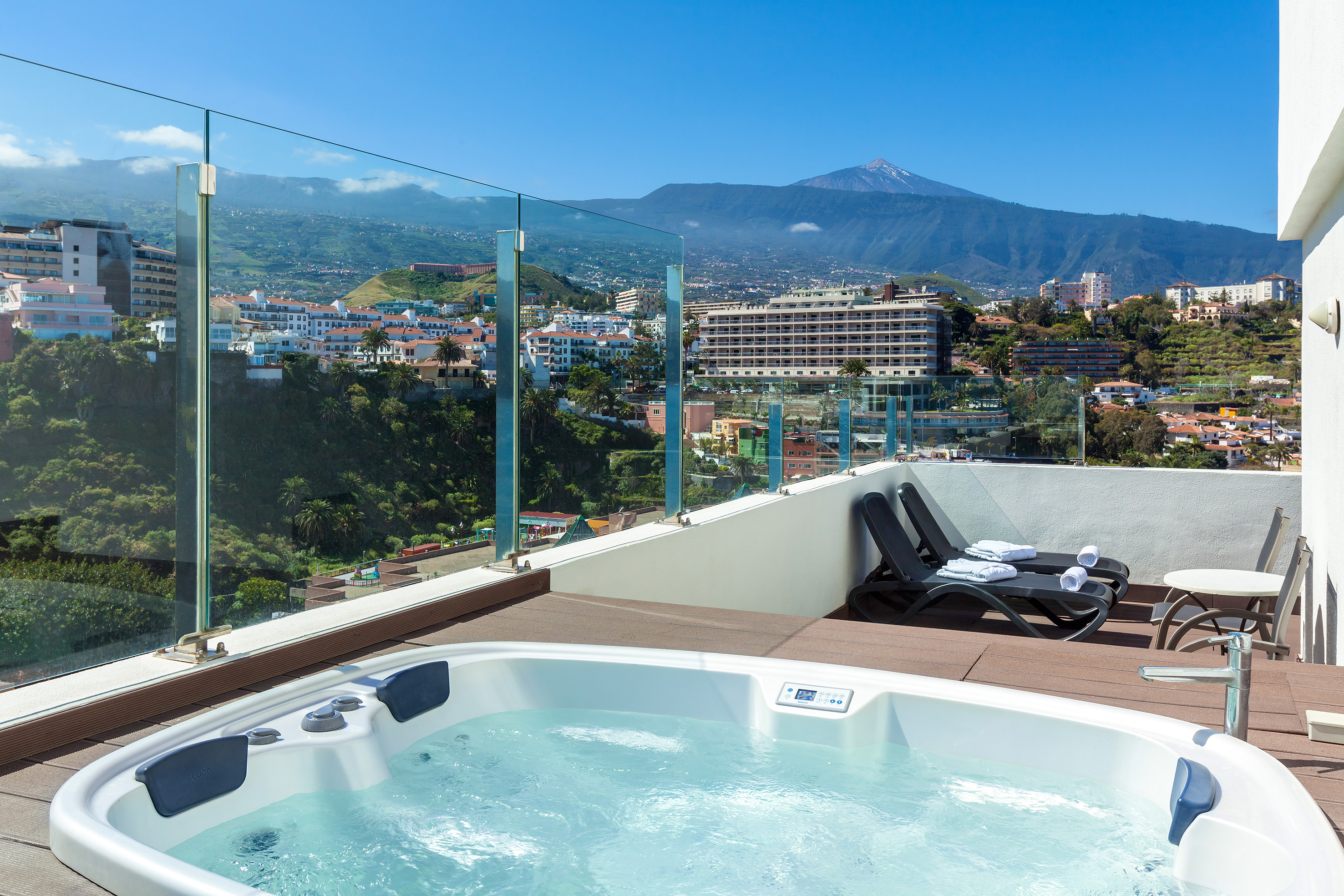 Terrace hot tub with scenic Puerto de la Cruz city and Mount Teide view.