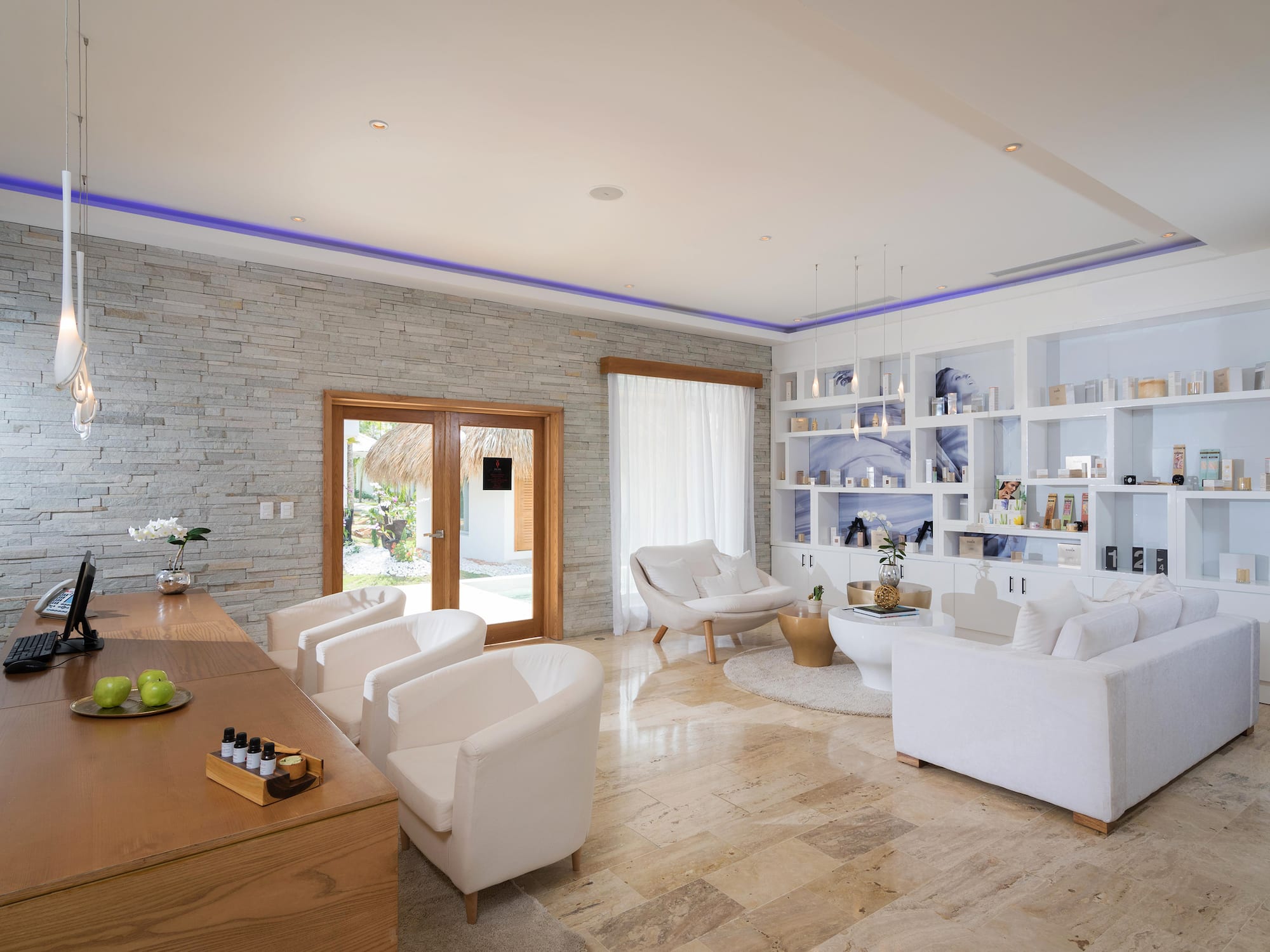 a room with white furniture and a table