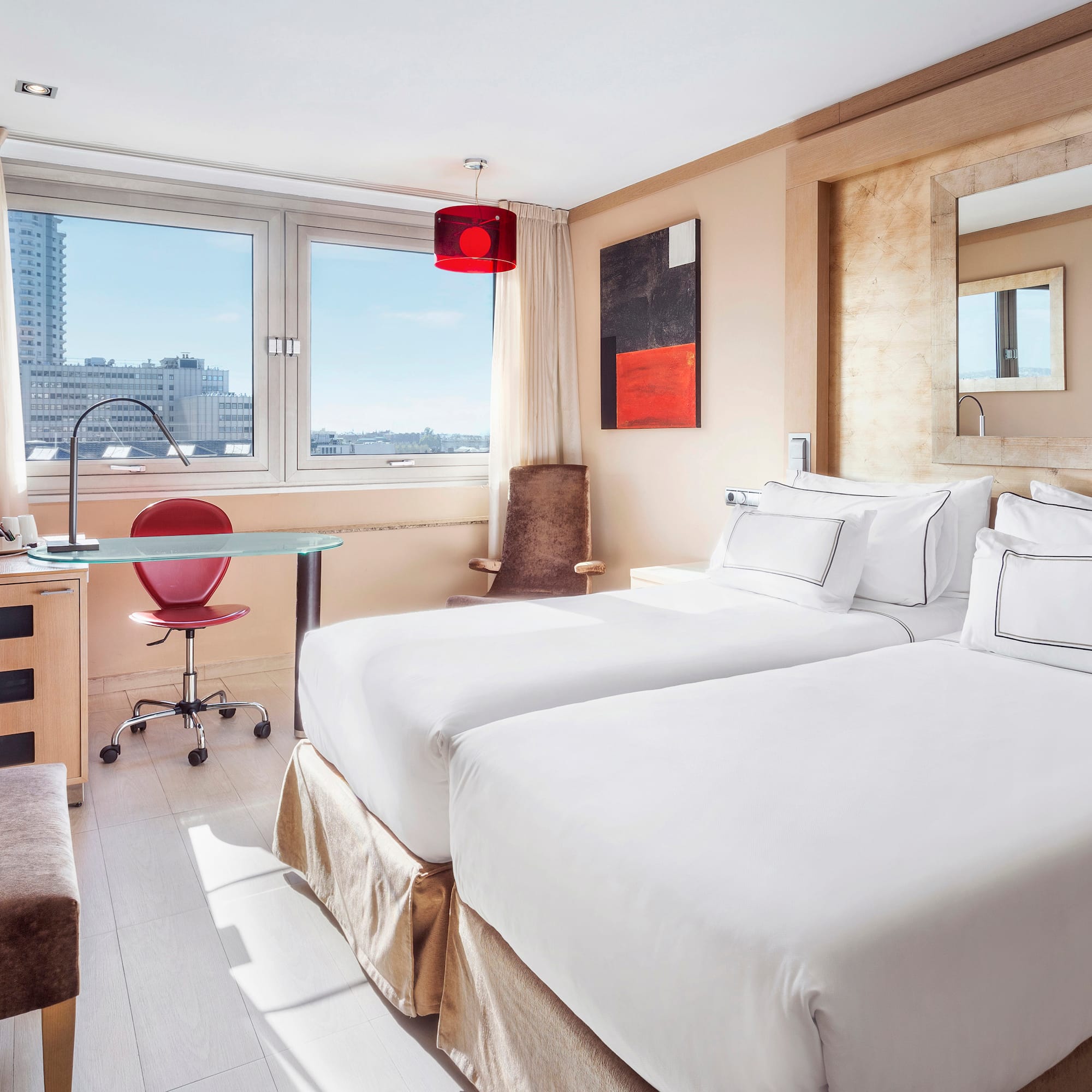 a room with two beds and a desk