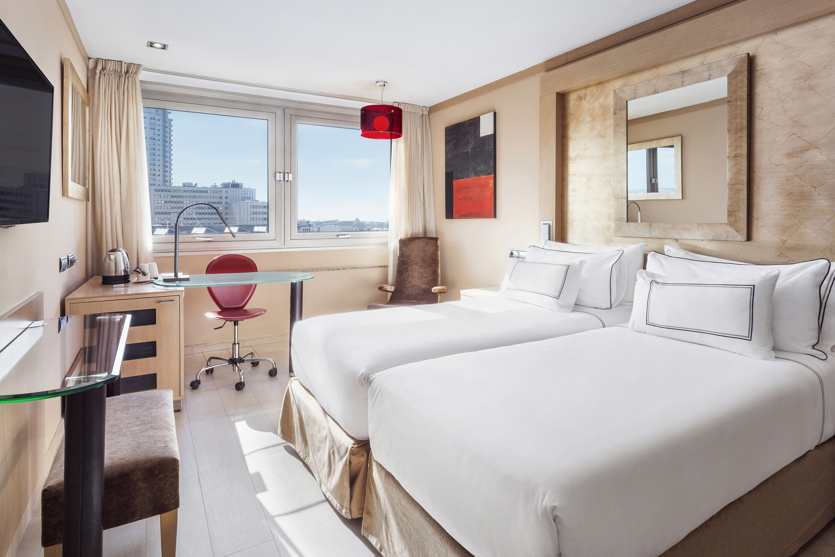 a room with two beds and a desk