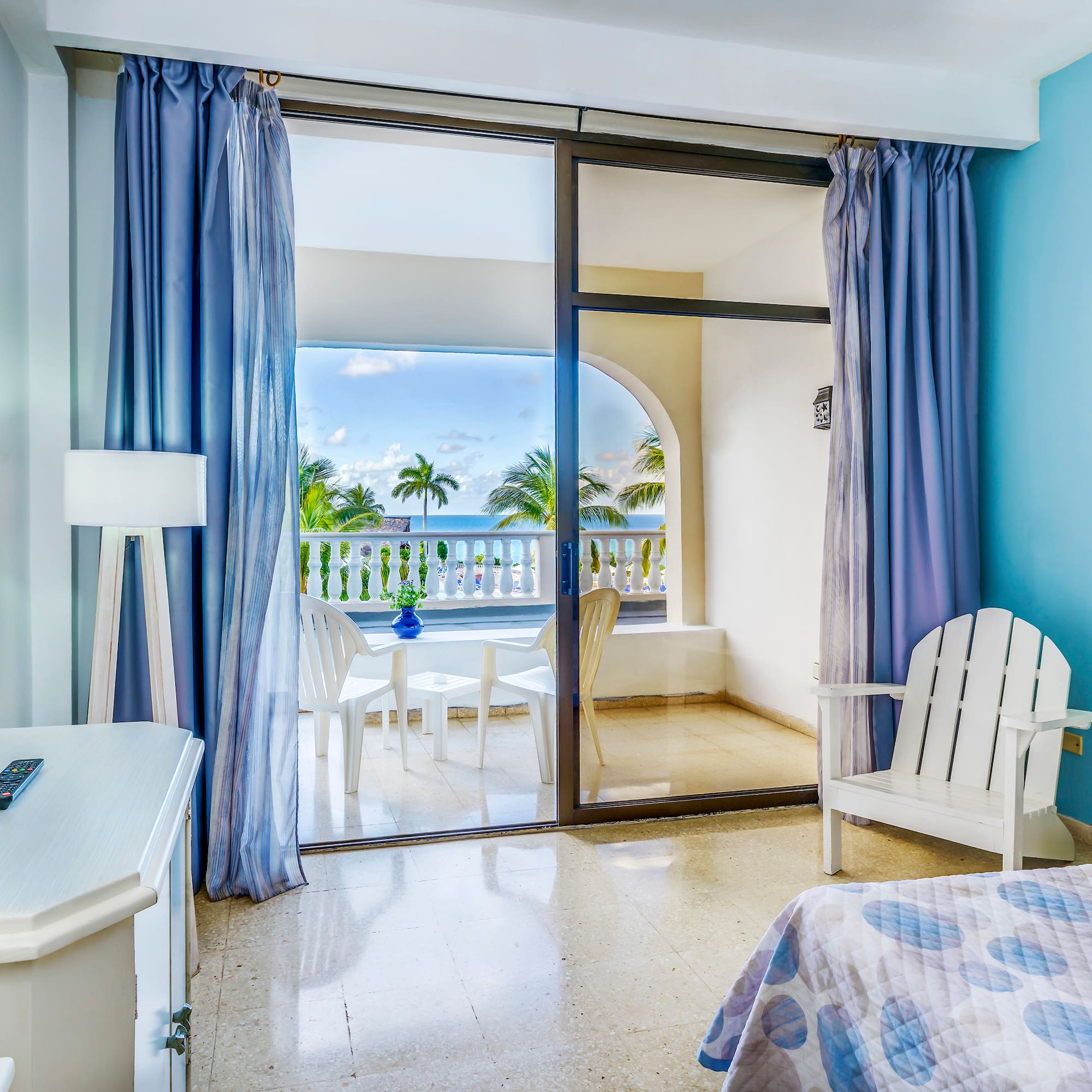 a bedroom with a glass door and a bed