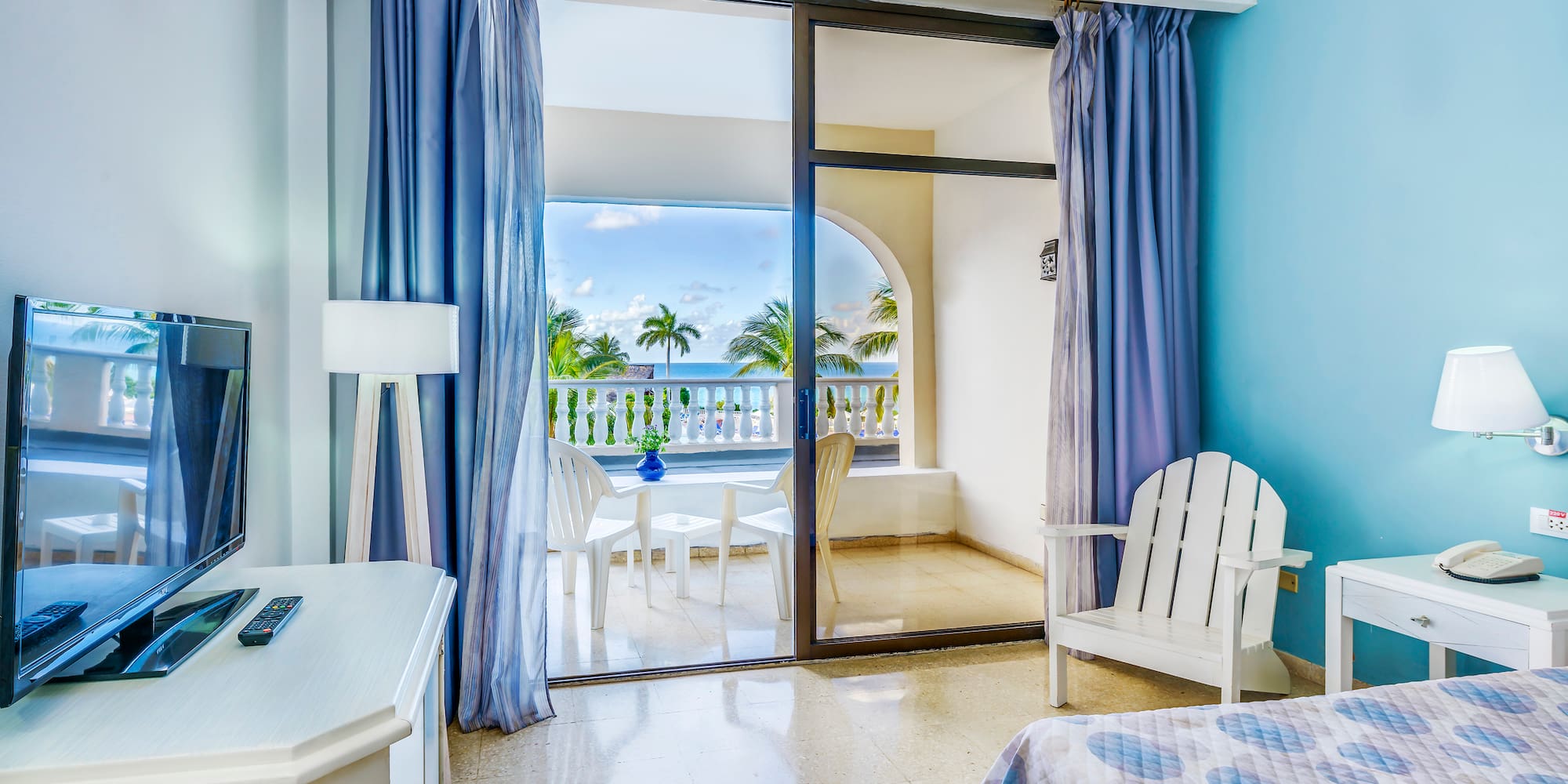 a bedroom with a glass door and a bed