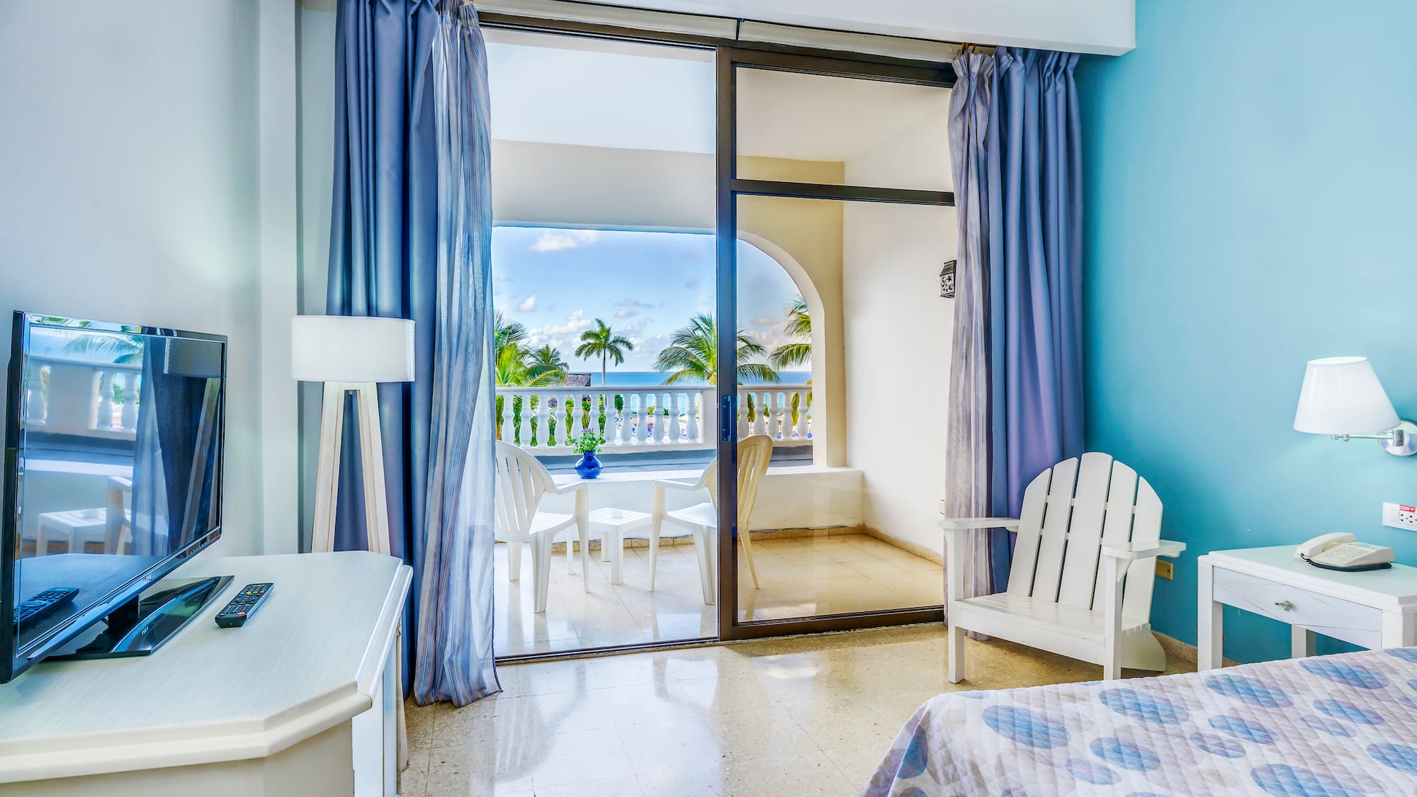 a bedroom with a glass door and a bed