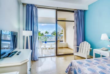 a bedroom with a glass door and a bed